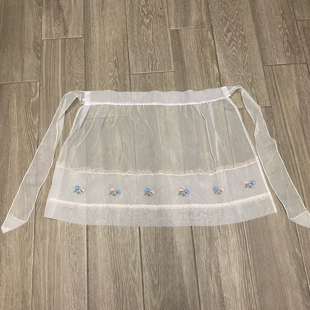 Vintage sheer apron with embroidered flowers.